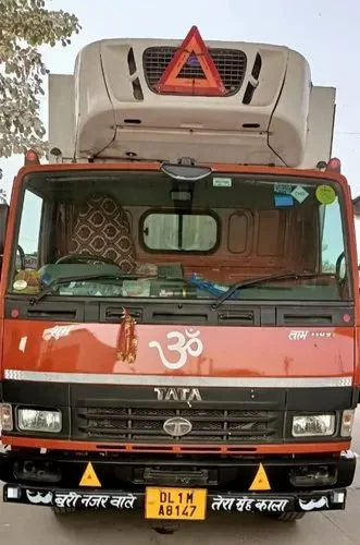 Front view of the red refrigerated TATA truck from RNR Logistics' container service listing.